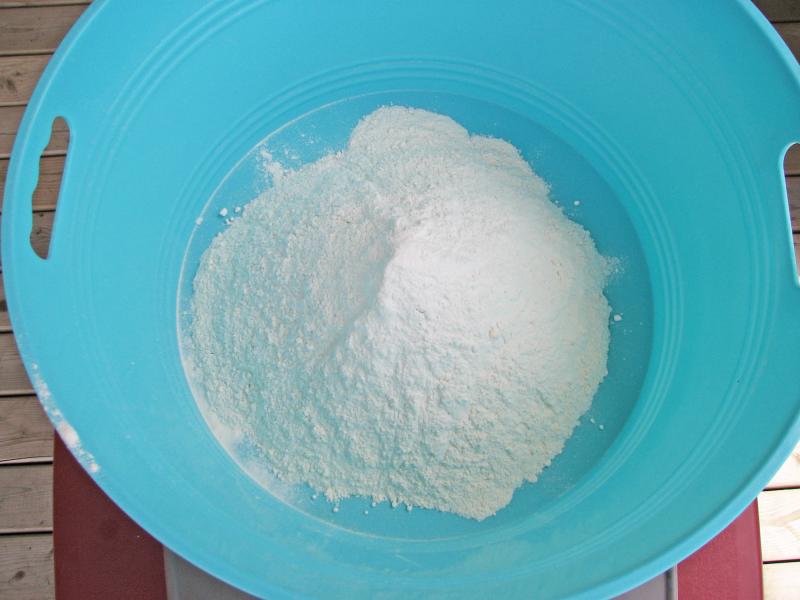 Put flour into a storage container.