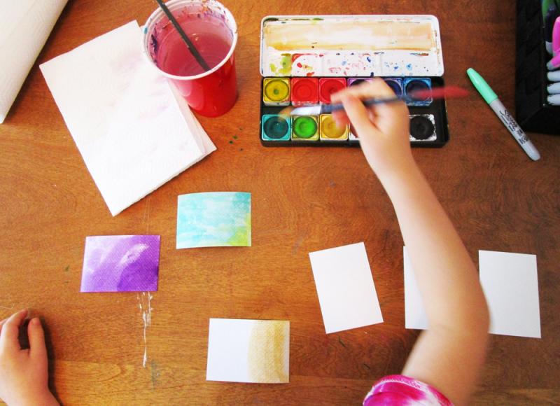 Use watercolour paints and markers to decorate artist trading cards.