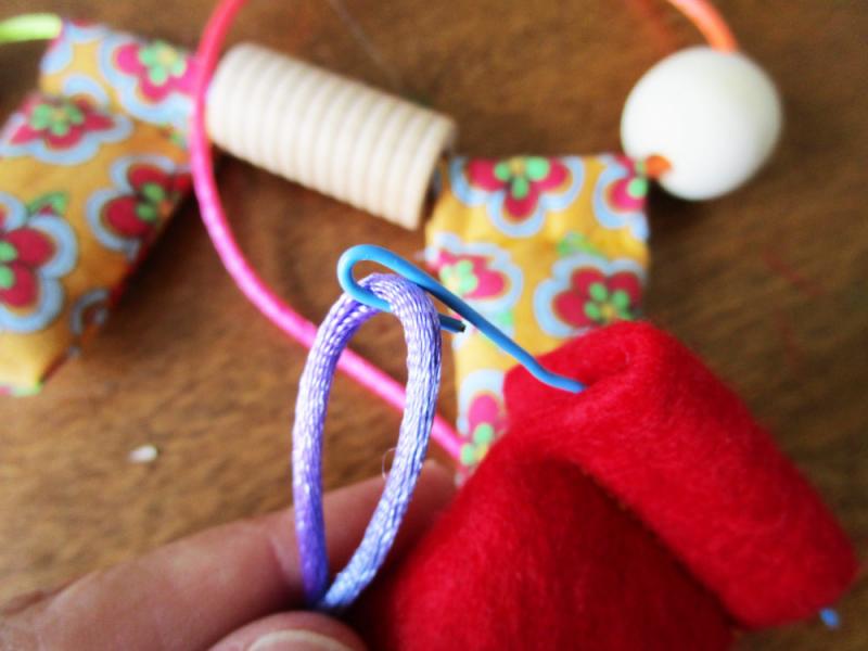 Use a paperclip to thread the fabric beads.