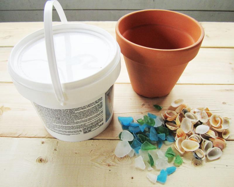 Gather drywall compound, a terracotta pot and some odds and sods (beach glass, seashells, etc.)